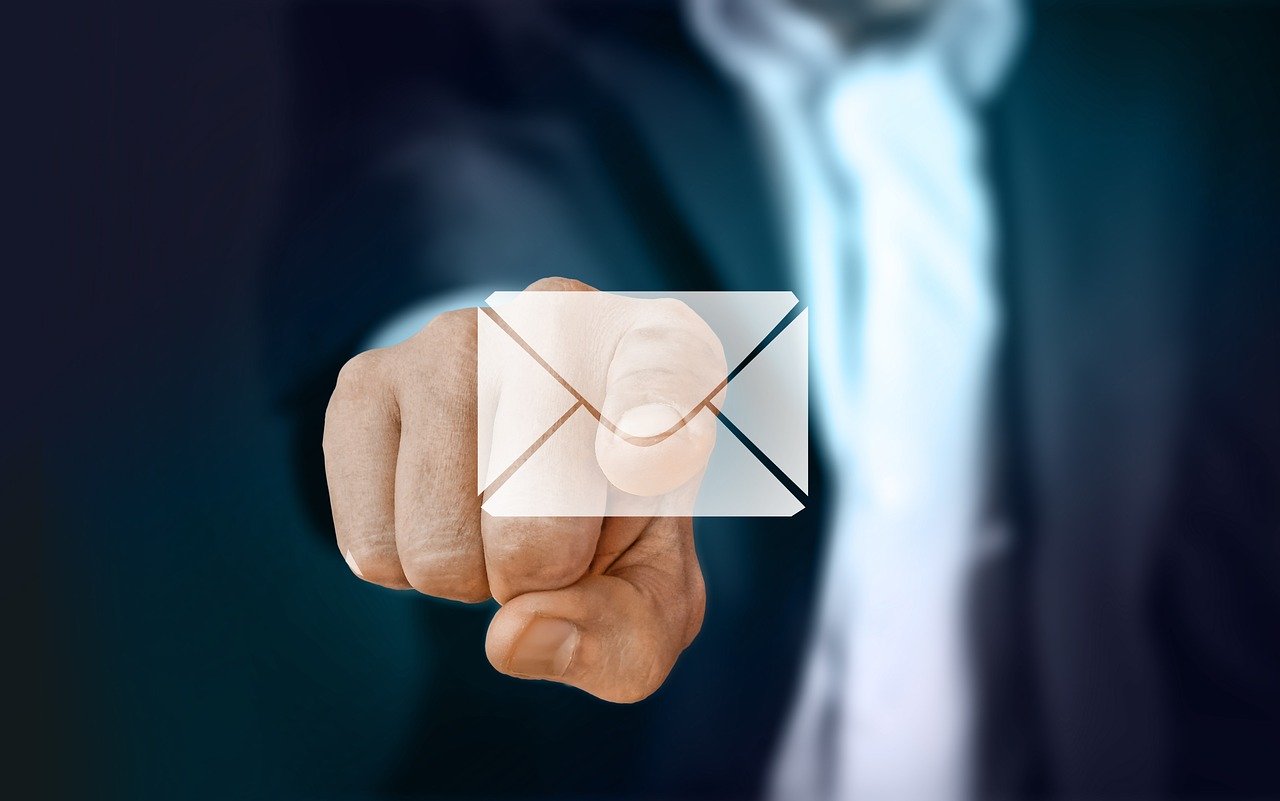 A finger pointing at an envelope icon.